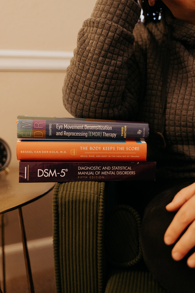 Bookshelf with carefully selected books in Ali Tipton's Tulsa therapy office