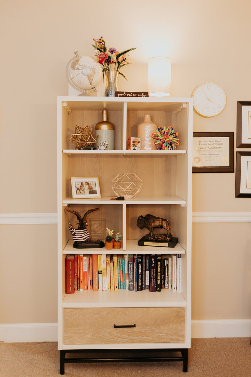 Bookshelf and decor in Ali Tipton's therapy office in Tulsa, Oklahoma